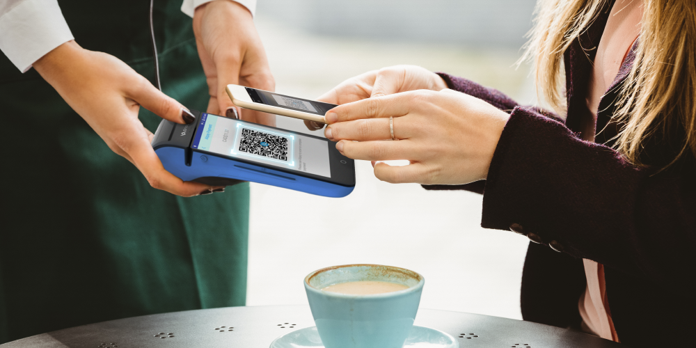 customer use mobile phone to scan qr-code on blue snappay stand-alone deivce